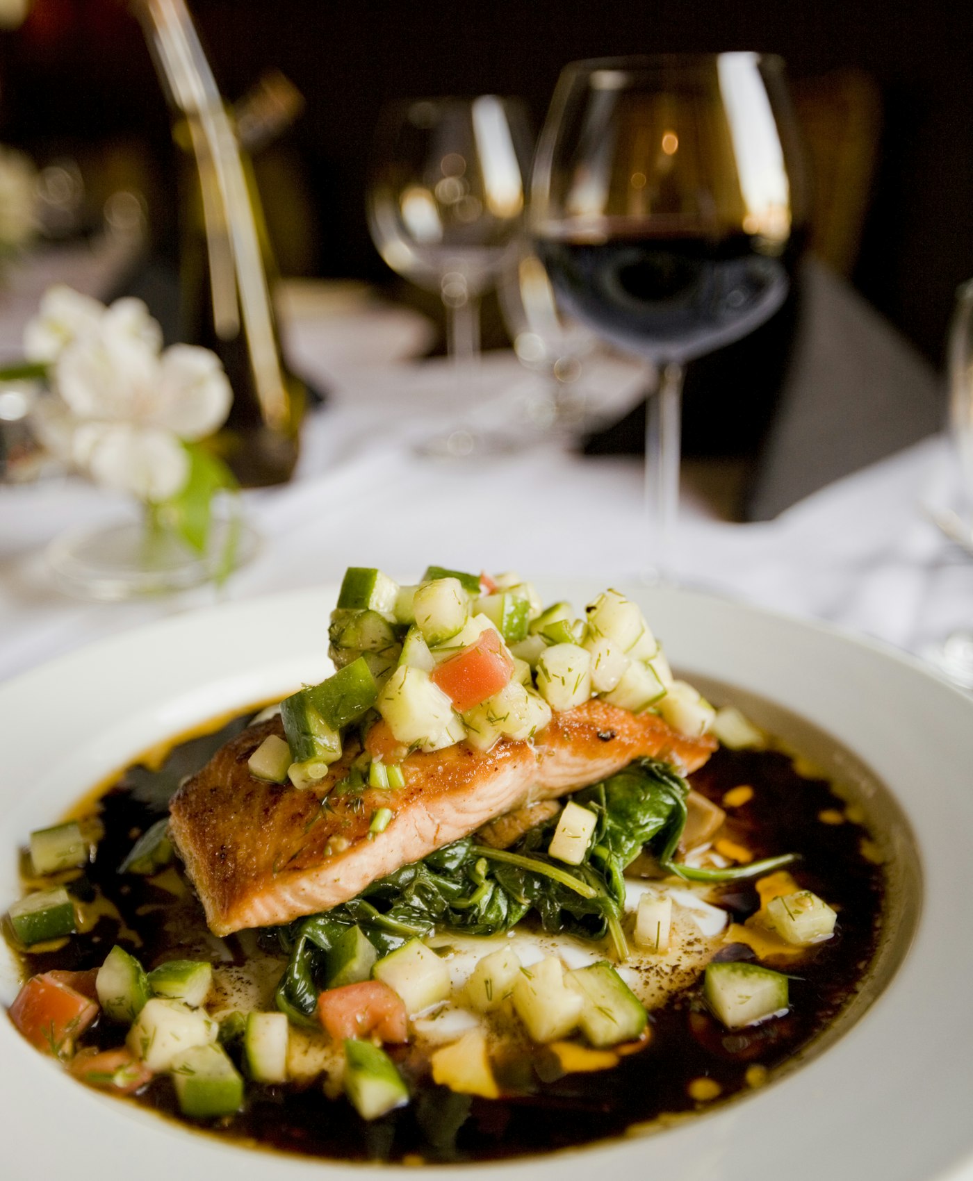 A plated grilled salmon fillet with herbs